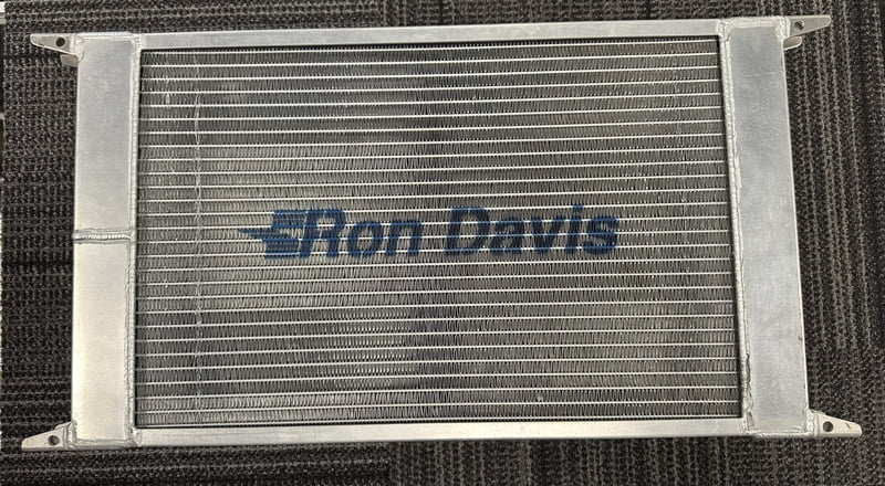 **Previous Display** 22" Wide x 13" High x 2" Thick, 5.50" Thick w/ Fan, 1-1/4" Hose Connection Inlet/Outlet Left or Right, No Fill, 1/4" NPT Drain/Bleed Bungs, Complete w/Spal Fan & Alum. Shroud, Designed For Both Door Slammers and Dragsters